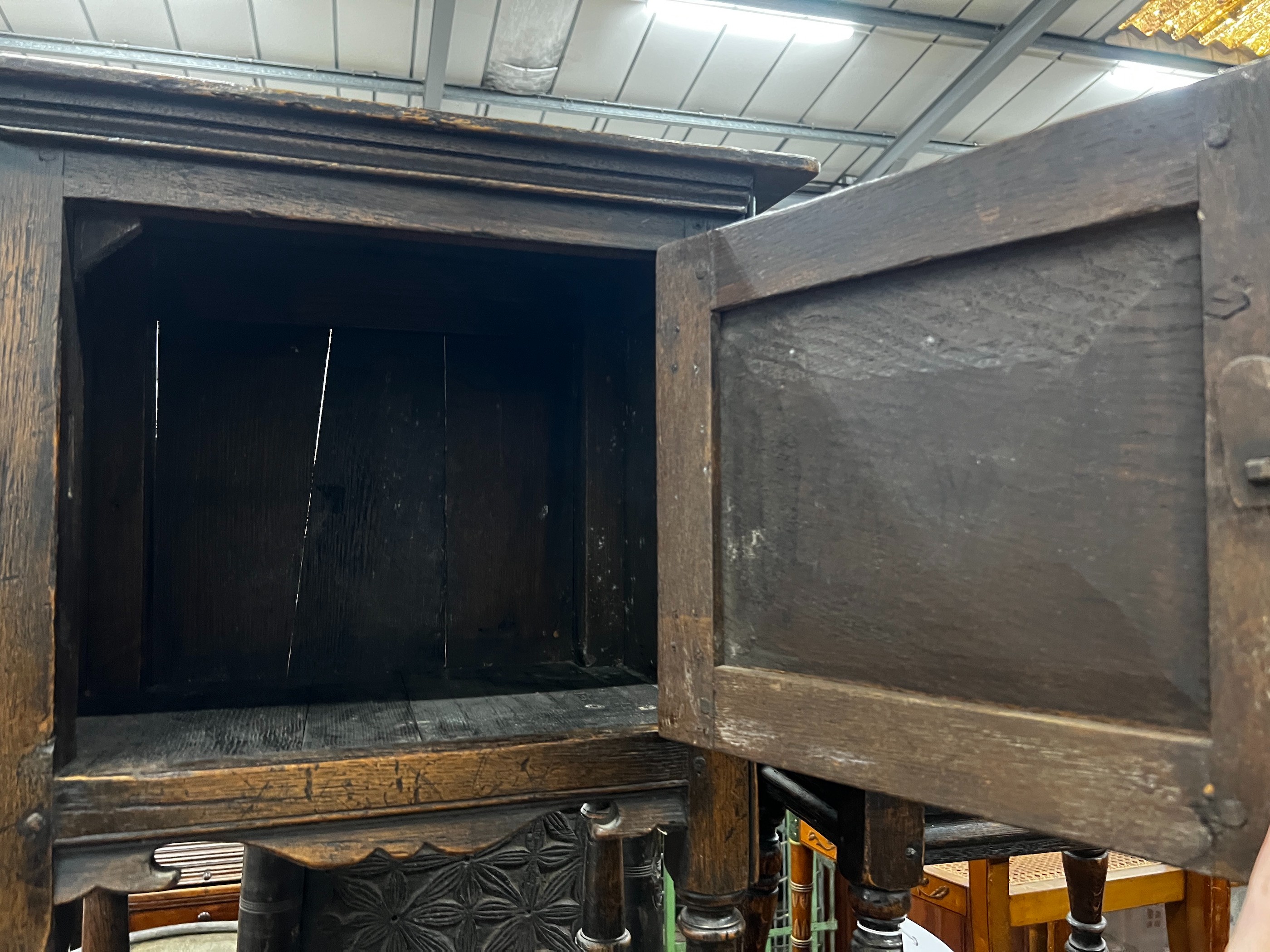 A small 17th century style carved oak side cabinet, width 53cm, depth 34cm, height 83cm